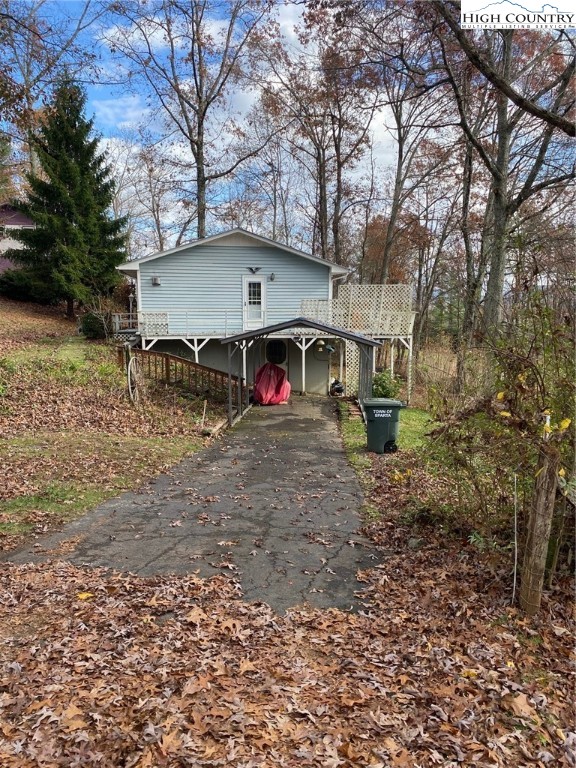 167 Grandridge Road Sparta, NC 28675 - Photo 2 of 29 a view of house with large trees and playing area