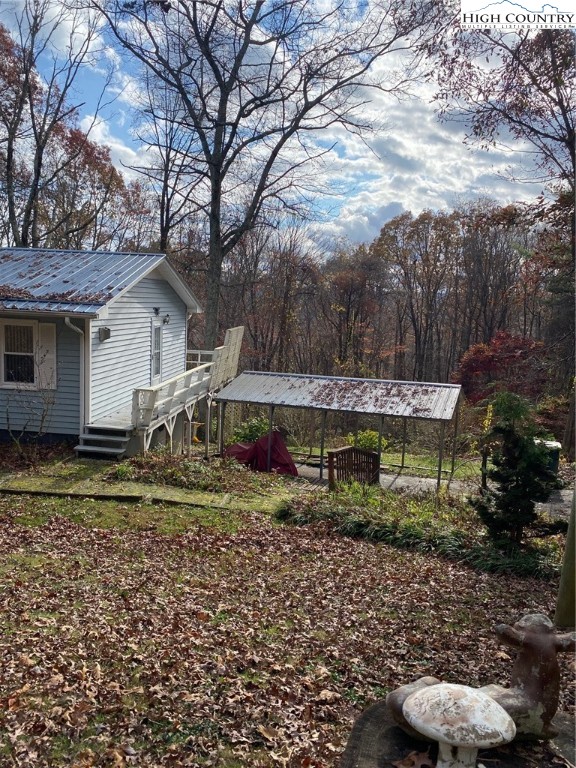 167 Grandridge Road Sparta, NC 28675 - Photo 25 of 29 a view of a yard with large trees and a barn