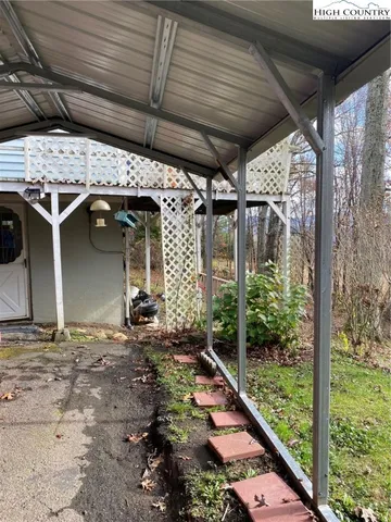 a view of a house with a yard and sitting area