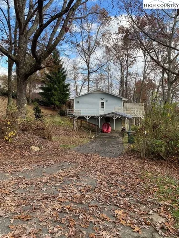 a view of dirt yard with a large tree