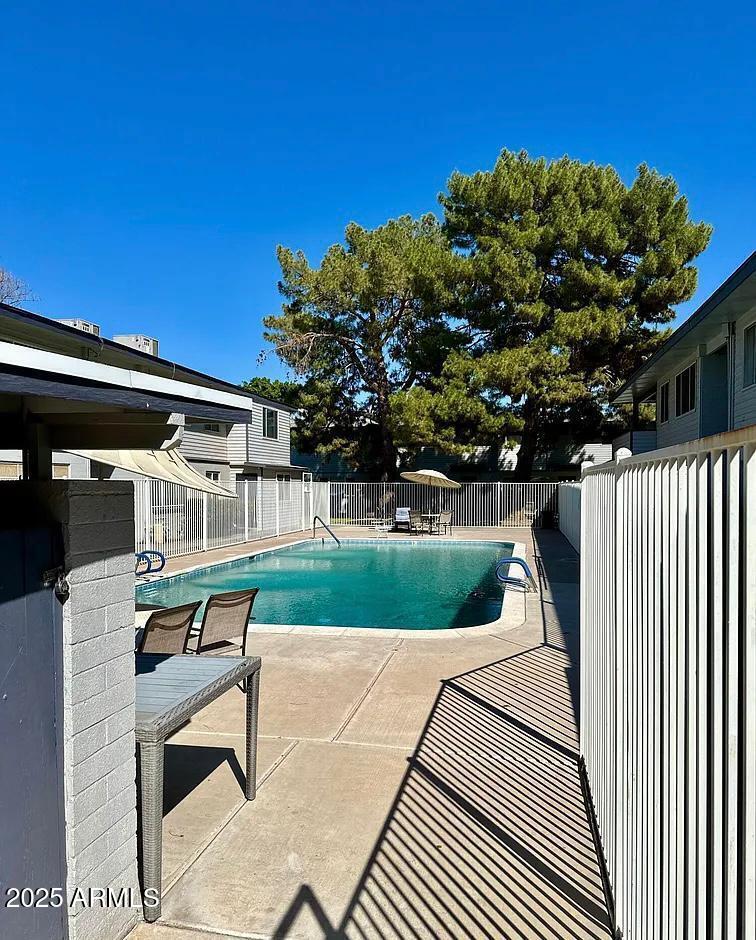 2551 West Rose Lane, Unit 222 Phoenix, AZ 85017 - Photo 11 of 12 a balcony with table and chairs