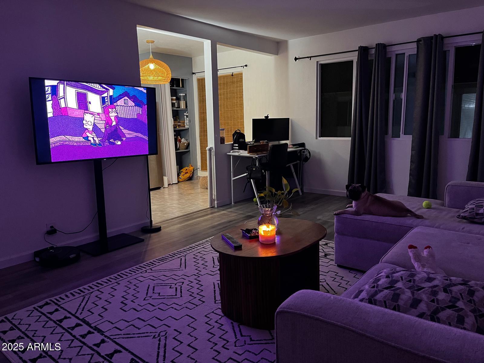 2551 West Rose Lane, Unit 222 Phoenix, AZ 85017 - Photo 2 of 12 a living room with furniture and a flat screen tv