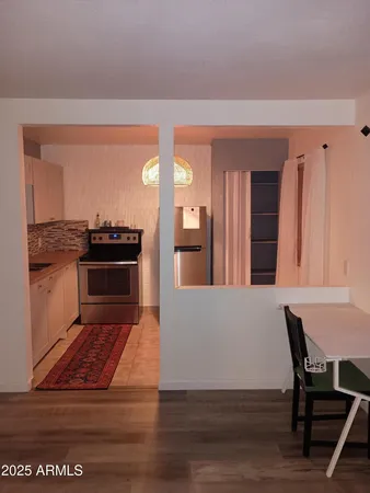 a living room with furniture stove and wooden floor