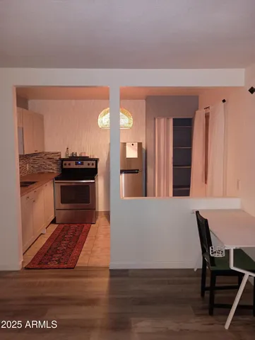 a living room with furniture stove and wooden floor