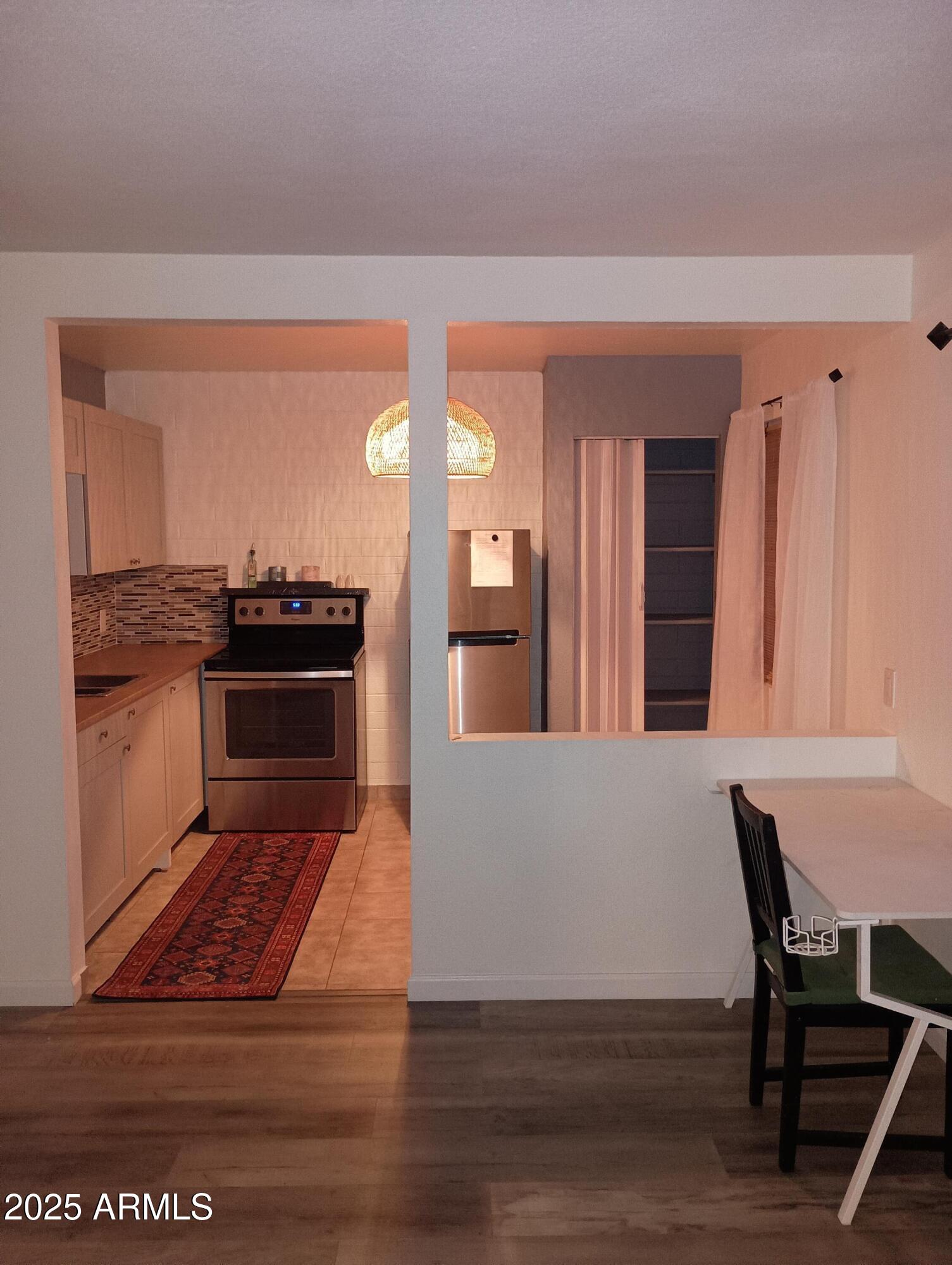 2551 West Rose Lane, Unit 222 Phoenix, AZ 85017 - Photo 3 of 12 a living room with furniture stove and wooden floor