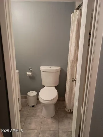 a white toilet sitting next to a sink