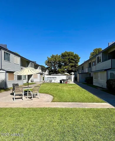 a swimming pool with outdoor seating and yard