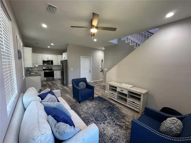 a living room with furniture and kitchen view