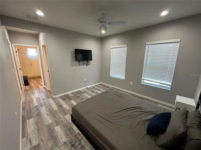 a bedroom with a bed and a television