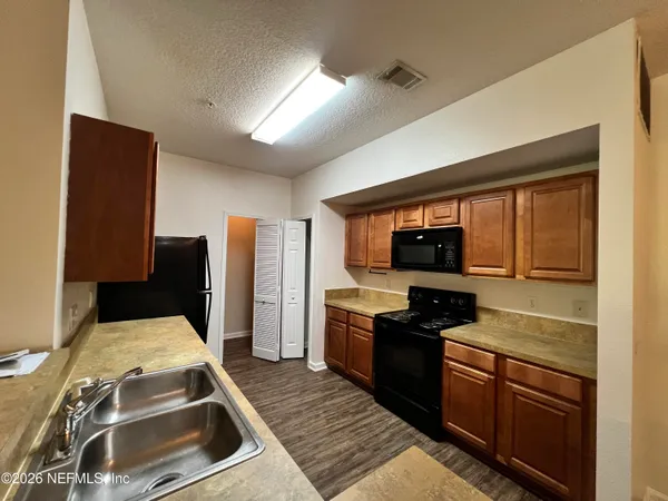 a kitchen with a stove and a refrigerator