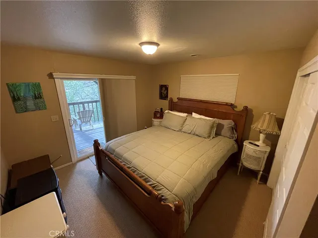 a bed sitting in a bedroom next to a window