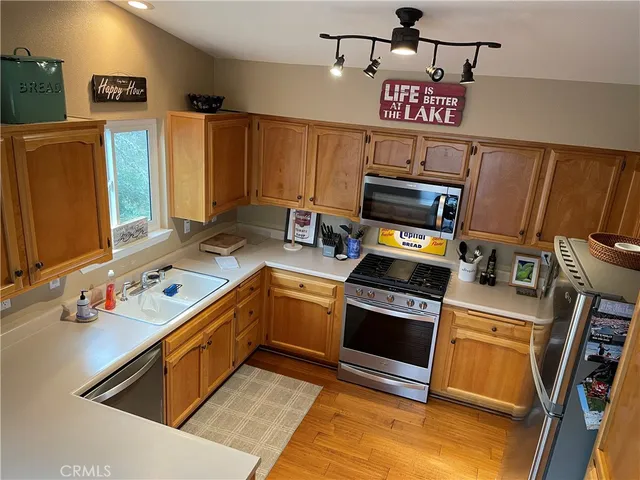 a kitchen with stainless steel appliances a stove a sink and a refrigerator