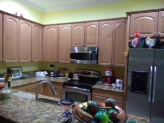 841 Northwest 82nd Lane Boca Raton, FL 33487 - Photo 3 of 9 a kitchen with a table chairs and a stove