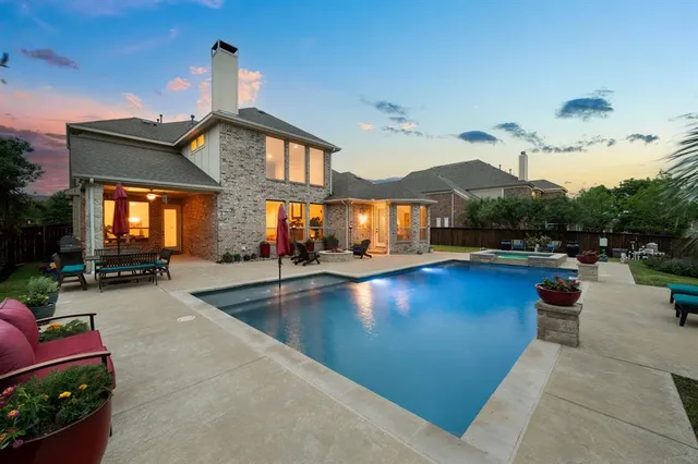 an outdoor space with swimming pool and furniture