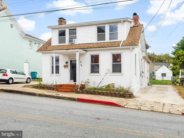 a front view of a house with a road