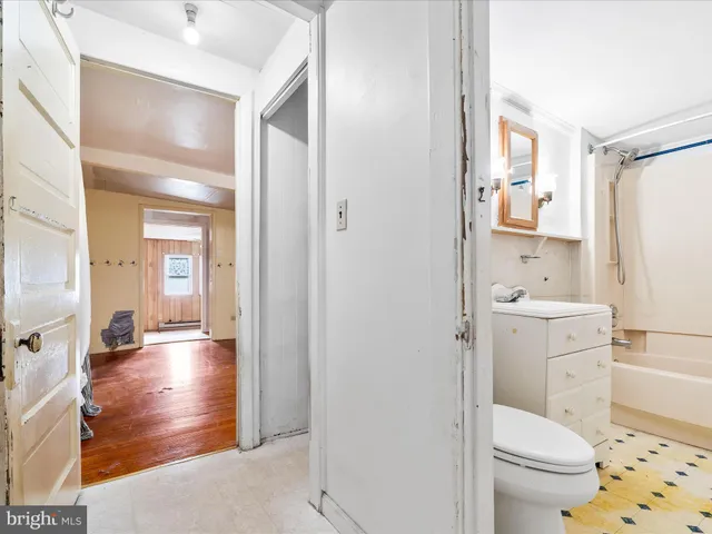 a bathroom with a sink toilet vanity and a mirror