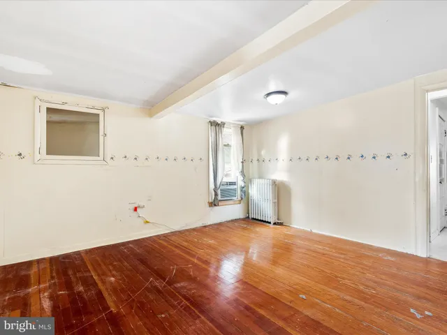 a view of a room with wooden floor and white walls