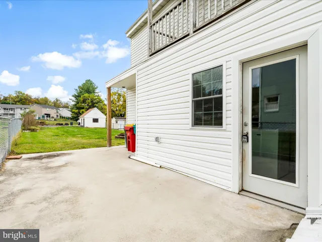 a view of a house with backyard and porch