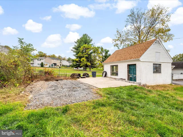 a view of a house with a yard and a garage