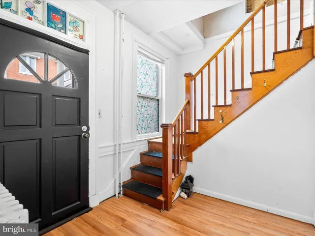 a view of an entryway with wooden floor and door