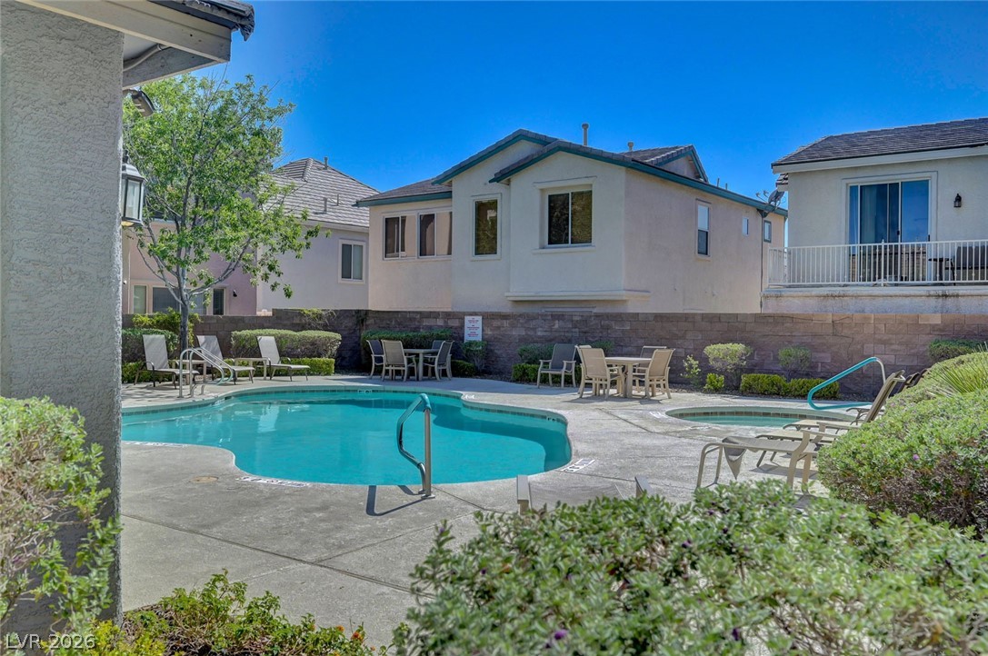 977 Sparkling Light Street Henderson, NV 89052 - Photo 9 of 75 This tranquil outdoor oasis features a refreshing pool, perfect for relaxation and recreation.