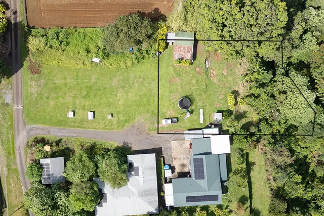 an aerial view of a residential apartment building with a yard