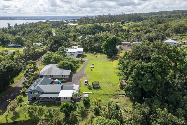 an aerial view of a house with a yard