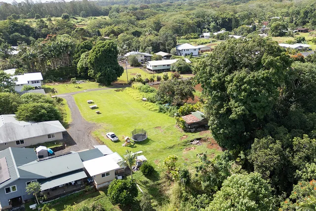 an aerial view of a house with yard swimming pool and lake view