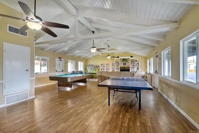 a room with lots of furniture and a wooden floor