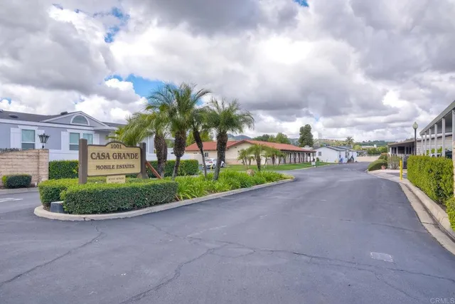 a view of a patio with table and chairs and a barbeque