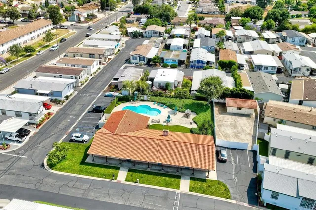 swimming pool view with a garden and seating space