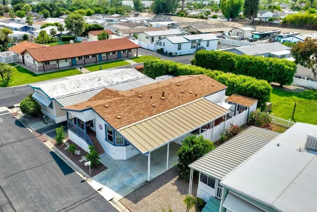 an aerial view of multiple houses with a yard