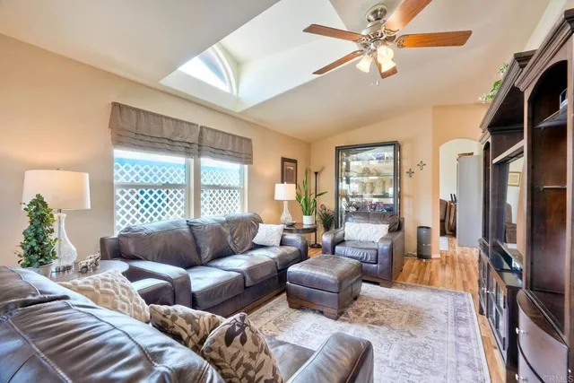 a living room with furniture fireplace and a large window