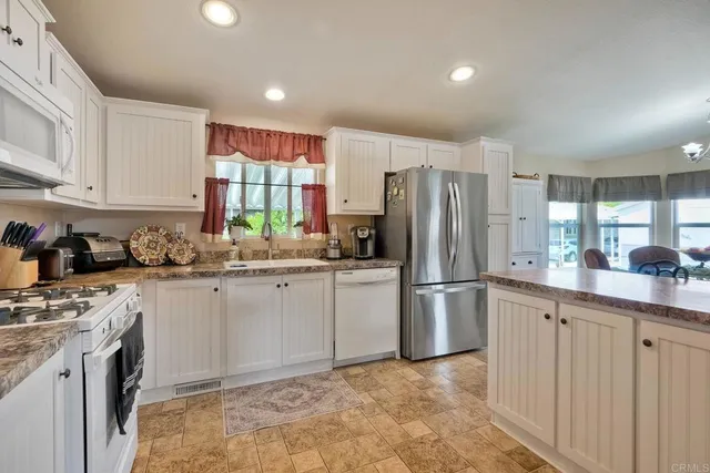 a kitchen with a refrigerator and a sink