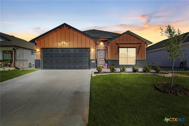 a front view of house with yard and green space