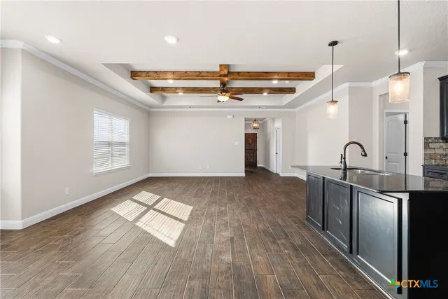 a view of a kitchen with a sink and wooden floor
