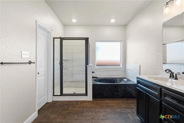 a view of a kitchen from a hallway