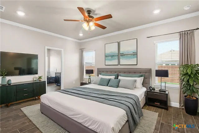 a bedroom with a large bed and a flat screen tv