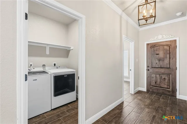 a view of a hallway with washer and dryer