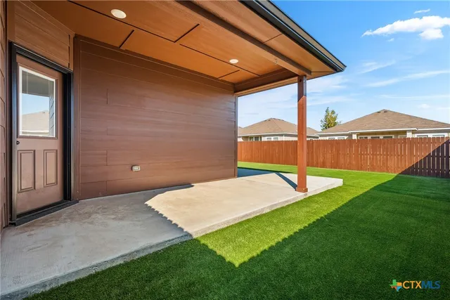 a view of a backyard with a garden and deck