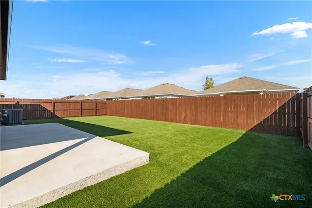 a view of a backyard with sitting area
