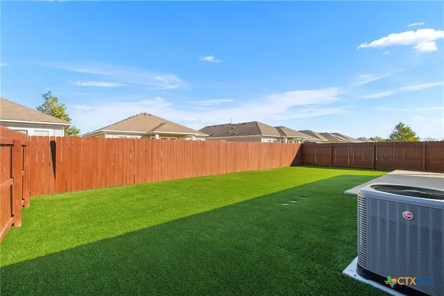 a view of a backyard with table and chairs