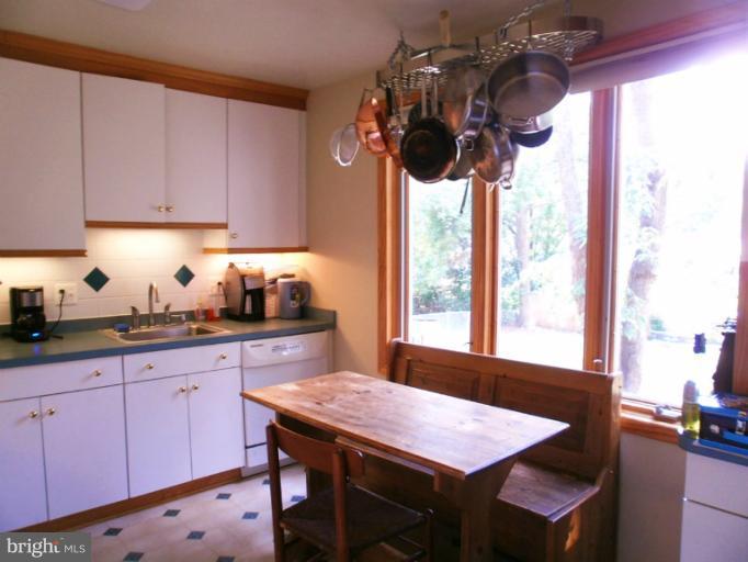 Kitchen with window overlooking backyard
