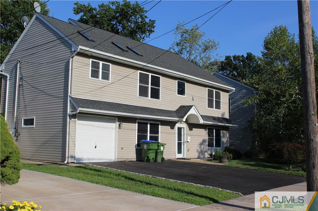 15 Kenmore Road Edison, NJ 08817 - Photo 2 of 35 a front view of a house with a yard and garage
