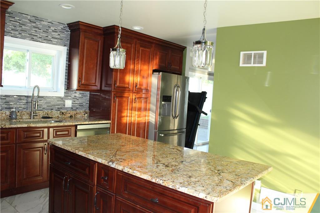 15 Kenmore Road Edison, NJ 08817 - Photo 11 of 35 a bathroom with a granite countertop sink and a mirror