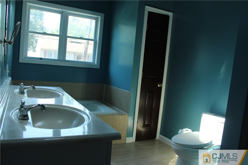 15 Kenmore Road Edison, NJ 08817 - Photo 15 of 35 a view of a sink and a mirror