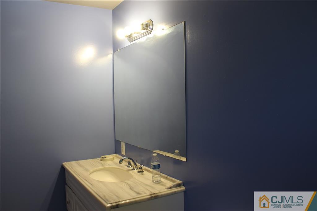 15 Kenmore Road Edison, NJ 08817 - Photo 17 of 35 a bathroom with a sink and a mirror