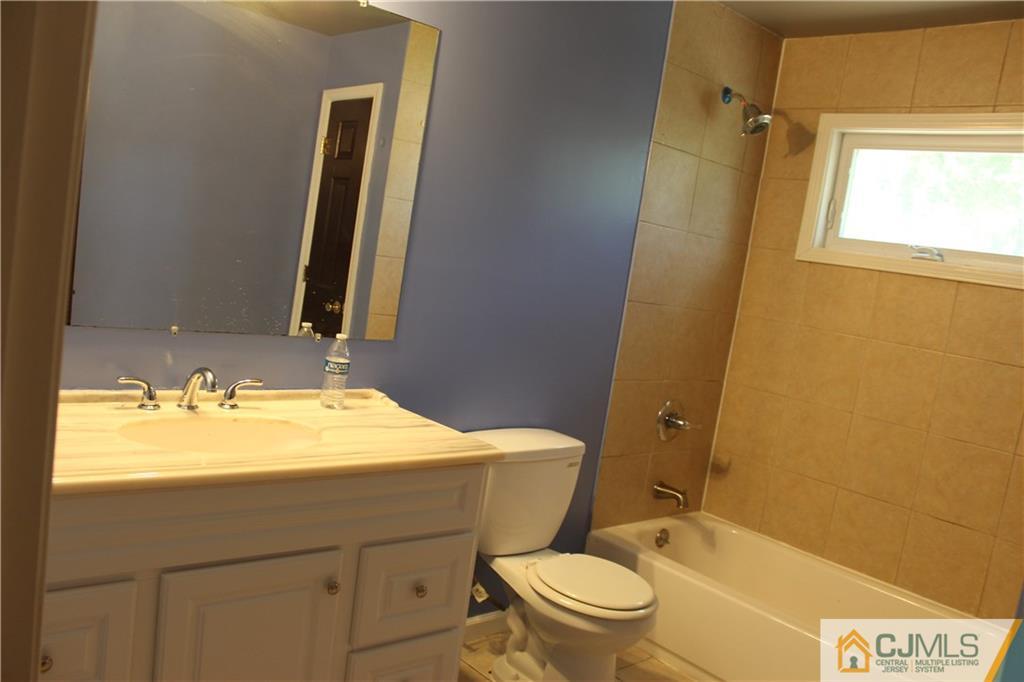 15 Kenmore Road Edison, NJ 08817 - Photo 20 of 35 a bathroom with a sink a toilet and shower