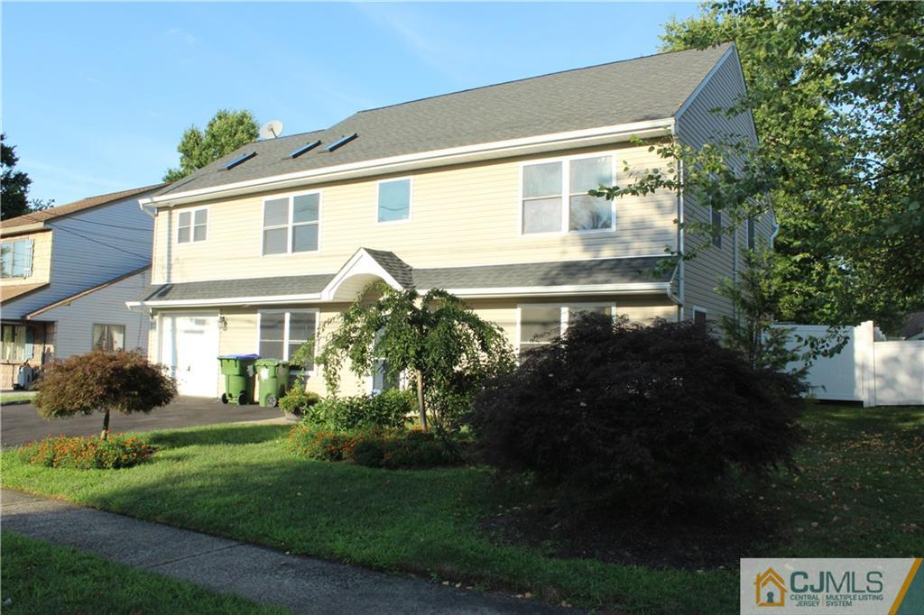 15 Kenmore Road Edison, NJ 08817 - Photo 3 of 35 a front view of a house with a yard and potted plants