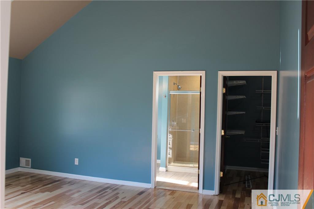 15 Kenmore Road Edison, NJ 08817 - Photo 21 of 35 an empty room with wooden floor and closet